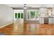Inviting living room with natural light, hardwood flooring, and adjacent kitchen featuring modern appliances at 1572 Hines Rd, Moreland, GA 30259