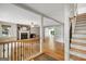 Open-concept living room with hardwood floors, a brick fireplace, and abundant natural light at 1572 Hines Rd, Moreland, GA 30259