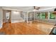 Open living area with gleaming hardwood floors, ceiling fan, wainscotting, and natural light throughout at 1572 Hines Rd, Moreland, GA 30259