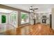 Open-concept area featuring hardwood floors, natural light, a cozy breakfast nook, and a view of the deck at 1572 Hines Rd, Moreland, GA 30259
