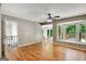 Bright living area with hardwood floors, large bay windows overlooking the deck, and an open doorway at 1572 Hines Rd, Moreland, GA 30259