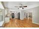 Open floor plan featuring the kitchen with stainless steel appliances and a spacious living area with wood floors at 1572 Hines Rd, Moreland, GA 30259