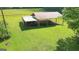 Outbuilding featuring a red metal roof with open sides and equipment parked underneath at 1572 Hines Rd, Moreland, GA 30259