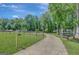 Scenic driveway leading through a grassy field; property offering picturesque rural views and serenity at 1572 Hines Rd, Moreland, GA 30259