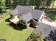 Rear exterior view showcasing the deck, screened-in porch, dark roof, and well-manicured lawn at 1572 Hines Rd, Moreland, GA 30259