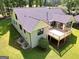 Back exterior of home with a spacious wooden deck, white brick, well maintained lawn, and a newly installed dark gray roof at 1572 Hines Rd, Moreland, GA 30259