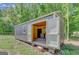 Exterior of shed with double doors open to the interior and windows, offering space and natural light at 1572 Hines Rd, Moreland, GA 30259