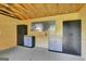 Shed interior features storage cabinets, work bench, peg board, and concrete flooring at 1572 Hines Rd, Moreland, GA 30259