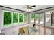 Bright sunroom features large windows overlooking the backyard and a ceiling fan at 1572 Hines Rd, Moreland, GA 30259