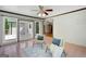 Bright sunroom features large windows and a ceiling fan at 1572 Hines Rd, Moreland, GA 30259