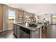 Modern kitchen with granite countertops, stainless steel appliances and open to living room at 170 Aster Ave, Locust Grove, GA 30248