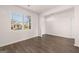 Spacious living room featuring hardwood floors and ample natural light from the large window at 170 Aster Ave, Locust Grove, GA 30248