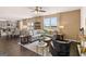 Spacious living room with a modern sectional sofa, hardwood floors, and abundant light at 170 Aster Ave, Locust Grove, GA 30248