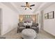 Stylish main bedroom features tray ceilings, seating area, and neutral decor at 170 Aster Ave, Locust Grove, GA 30248