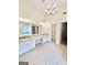 Bright bathroom with double vanities, tile floors, a large mirror, and a glass-enclosed shower at 759 Hennepin Ter, Mcdonough, GA 30253