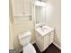 Bathroom with toilet, single sink vanity with white cabinets at 759 Hennepin Ter, Mcdonough, GA 30253