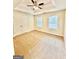 A carpeted primary bedroom with two windows and a ceiling fan at 759 Hennepin Ter, Mcdonough, GA 30253