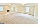 Large bonus room with fireplace, carpeted floor, and bright windows, perfect for entertainment or relaxation at 759 Hennepin Ter, Mcdonough, GA 30253