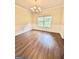Dining room featuring hardwood floors, wainscoting, and a decorative chandelier at 759 Hennepin Ter, Mcdonough, GA 30253