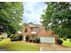 Charming two-story brick home with lush landscaping, a well-manicured lawn, and an attached two-car garage at 759 Hennepin Ter, Mcdonough, GA 30253