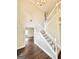 Bright foyer with soaring ceilings, wooden floors, and a staircase leading to the upper level at 759 Hennepin Ter, Mcdonough, GA 30253