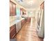 Modern kitchen featuring stainless steel appliances, granite countertops, wood cabinets, and wood flooring at 759 Hennepin Ter, Mcdonough, GA 30253