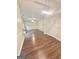 Spacious living room with hardwood flooring and a modern light fixture at 759 Hennepin Ter, Mcdonough, GA 30253