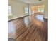 Open-concept living room with hardwood floors and lots of natural light at 759 Hennepin Ter, Mcdonough, GA 30253