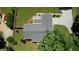 Birds eye view of home with shingled roof, large deck with a sun awning, and well maintained landscaped yard at 1130 Rawlings Dr, Rutledge, GA 30663
