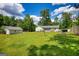 Large backyard and green lawn with a detached garage and privacy fence at 1130 Rawlings Dr, Rutledge, GA 30663