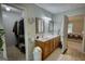 Bathroom featuring a double vanity, framed mirrors, closet, and an open doorway to bedroom at 1130 Rawlings Dr, Rutledge, GA 30663
