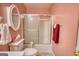 Pink bathroom featuring a toilet and shower with sliding glass doors at 1130 Rawlings Dr, Rutledge, GA 30663