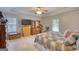 Bright bedroom with a large bed, dresser, mounted TV, and tray ceiling with fan at 1130 Rawlings Dr, Rutledge, GA 30663
