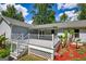 View of large white deck with awning, white railing, and security system sign at 1130 Rawlings Dr, Rutledge, GA 30663