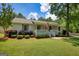 Charming home features a well-manicured lawn, an inviting porch, and delightful landscaping for great curb appeal at 1130 Rawlings Dr, Rutledge, GA 30663