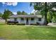 Charming home features a well-manicured lawn, an inviting porch, and delightful landscaping for great curb appeal at 1130 Rawlings Dr, Rutledge, GA 30663