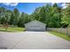 Close up of detached garage with concrete parking pad in the front and partially fenced yard at 1130 Rawlings Dr, Rutledge, GA 30663