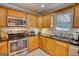 Well-lit kitchen features light-colored cabinetry, stainless steel appliances, and black countertops at 1130 Rawlings Dr, Rutledge, GA 30663