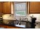 Kitchen area features stainless steel sink and faucet, granite countertops, and marble subway tile at 1130 Rawlings Dr, Rutledge, GA 30663