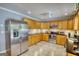 Clean kitchen featuring stainless steel appliances, wooden cabinets, granite counters, and tile floors at 1130 Rawlings Dr, Rutledge, GA 30663