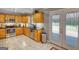 Bright and modern kitchen with stainless steel appliances, wood cabinets, and outdoor access to the deck at 1130 Rawlings Dr, Rutledge, GA 30663
