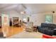 Open living room with hardwood floors, ceiling fan, and comfortable seating flowing into dining area at 1130 Rawlings Dr, Rutledge, GA 30663