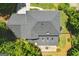 A close up, aerial shot of a home's roof, deck and yard, showcasing the structure and property layout at 1850 Linnet Ne Ct, Roswell, GA 30075