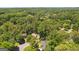 Aerial shot of a neighborhood with homes nestled among dense green trees at 1850 Linnet Ne Ct, Roswell, GA 30075