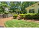 Backyard featuring lush greenery, a well-maintained lawn, and a wooden fence at 1850 Linnet Ne Ct, Roswell, GA 30075