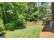 Spacious backyard featuring a well-maintained lawn, wooden fence, and lush greenery at 1850 Linnet Ne Ct, Roswell, GA 30075