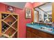 Cozy bar area featuring a wine rack, mirrored wall, and teal countertop at 1850 Linnet Ne Ct, Roswell, GA 30075
