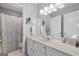 Bright bathroom with a framed mirror, vanity, and a shower/tub combo with curtain at 1850 Linnet Ne Ct, Roswell, GA 30075