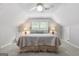 Cozy bedroom features a ceiling fan, dormer windows, and sloped ceilings at 1850 Linnet Ne Ct, Roswell, GA 30075
