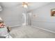 Neutral bedroom features plush carpeting, ceiling fan, and adjacent bathroom access at 1850 Linnet Ne Ct, Roswell, GA 30075